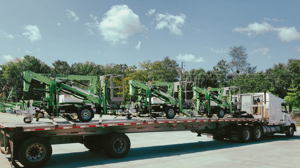 Image: IRF Transport flatbed shipping truck preparing to haul heavy machinery.